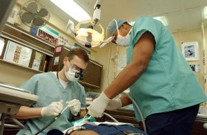 1200px-US_Navy_030124-N-1328C-510_Navy_dentist_treats_patients_aboard_ship
